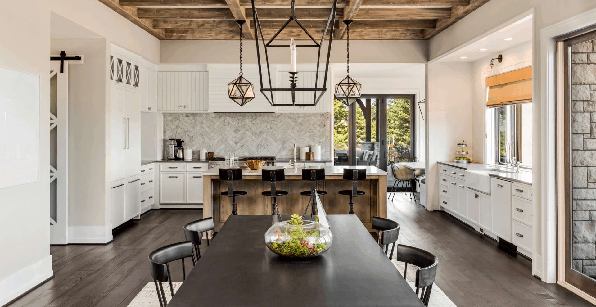 Modern kitchen with a large island and stylish pendant lights.