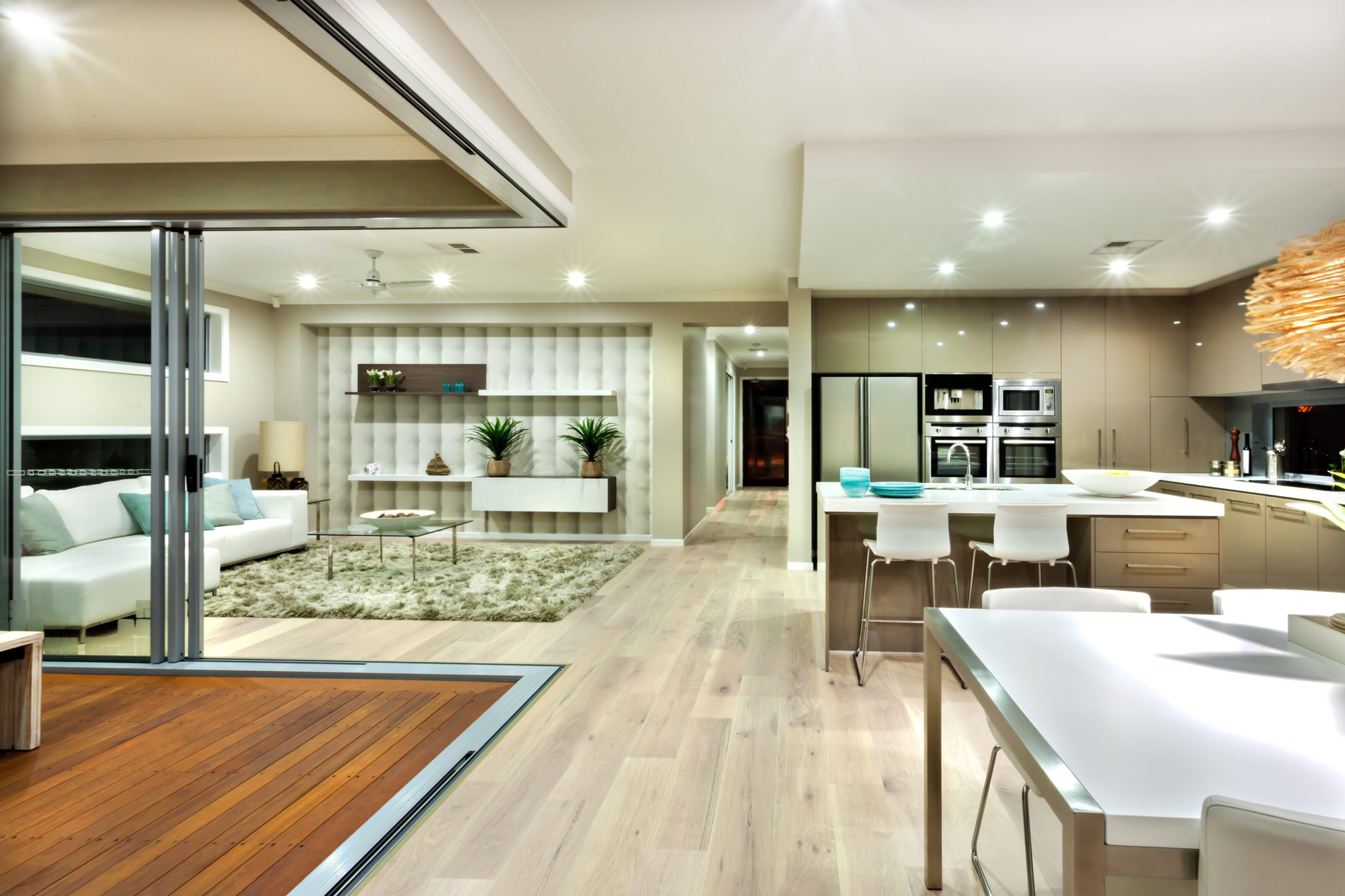 Modern kitchen with sleek appliances and open shelving.